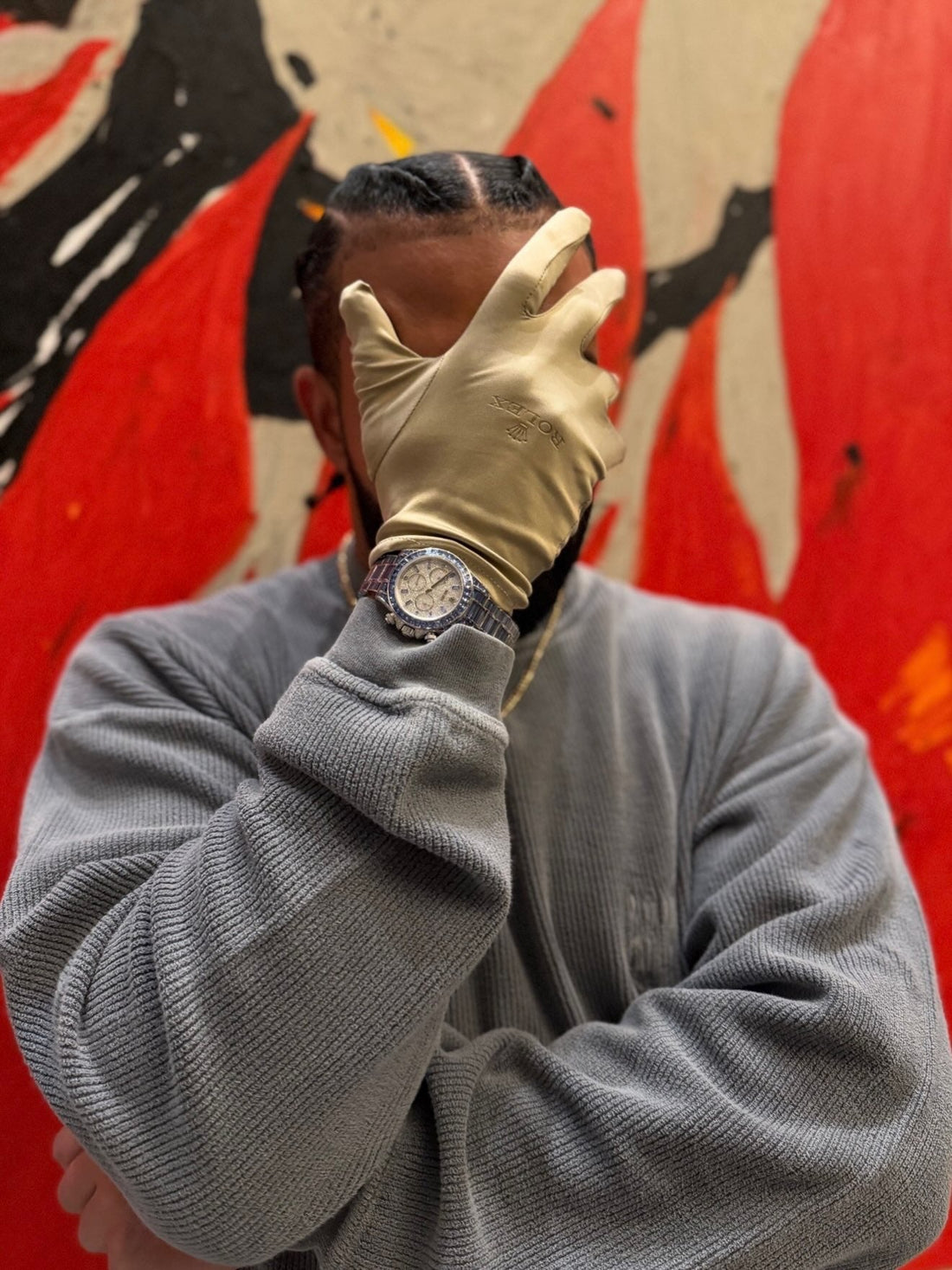 Drake wearing the Ice Gradient Daytona with a Rolex glove, wrist detail