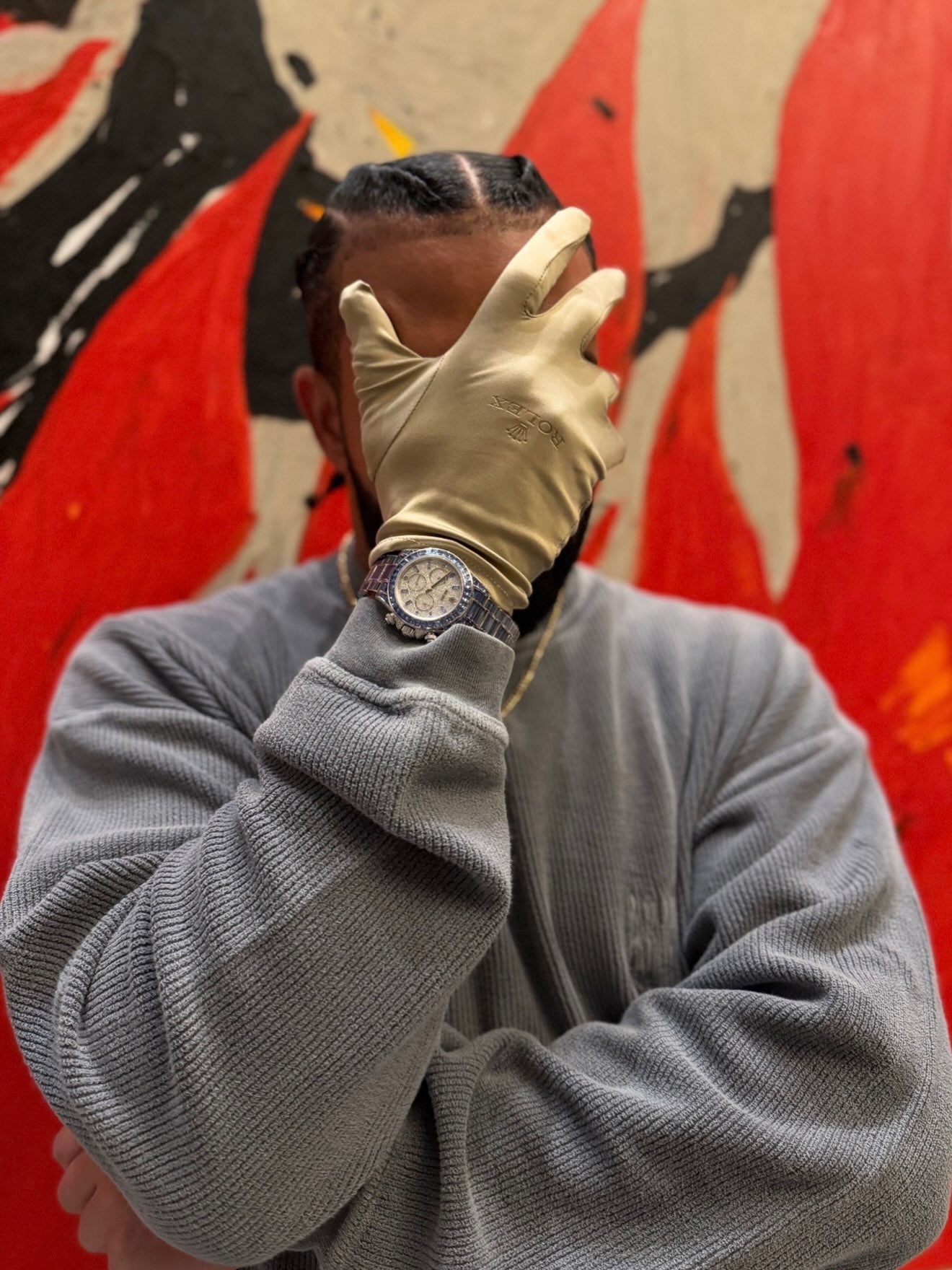 Drake wearing the Ice Gradient Daytona with a Rolex glove, wrist detail