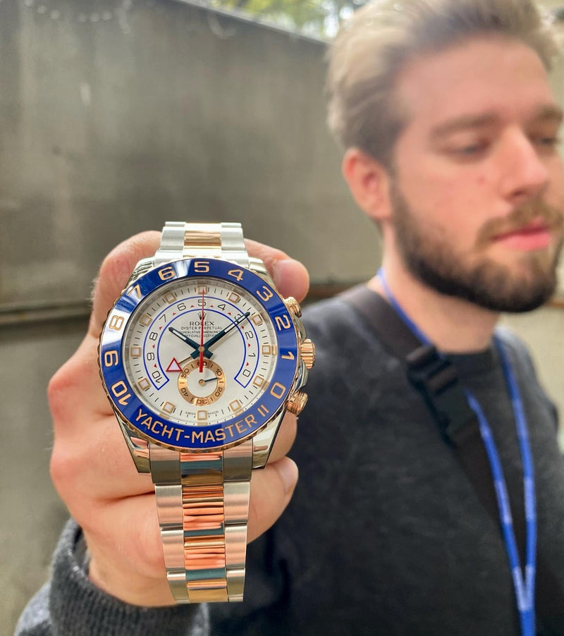 Raw portrait of Mathew Arena holding a Rolex watch